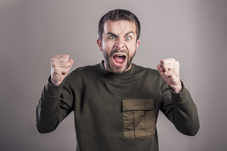 Angry enraged man yelling loudly, cant hold his frustrationの写真素材