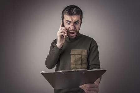 Young man reviewing the invoice, yelling at the company, seeing errors in numbers