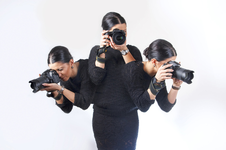 Busy photographer, lady capturing three images at the same time, one body - three motionsの写真素材