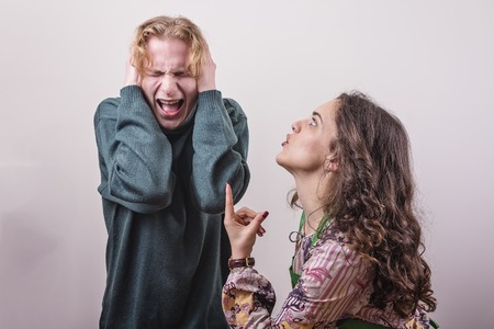 Married couple issues, young wife yelling at her husband, husband feeling abused and cant listen to herの写真素材