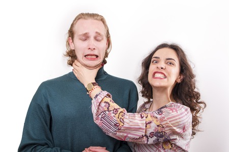 Married couple problems, wife choking her husband, furious with himの写真素材
