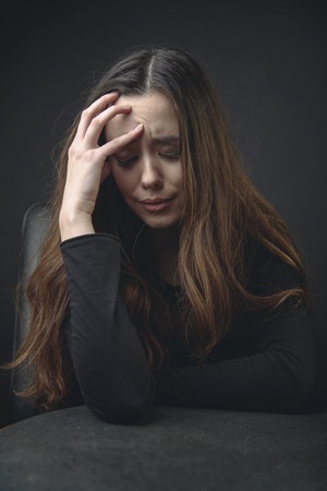Young beautiful woman feeling very sad and depressed