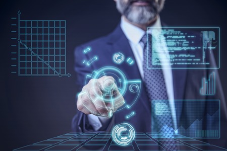 Virtual trading, stock and commerce - senior elderly business man choosing from a futuristic interfaceの写真素材
