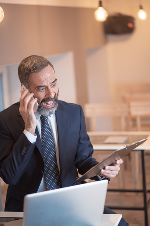 Angry business man yelling at his employee for a mistake made on official reportsの写真素材