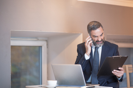 Angry business man yelling at his employee for a mistake made on official reportsの写真素材