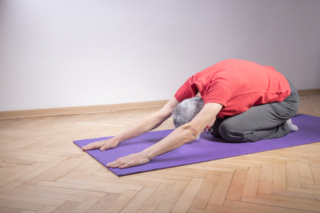 Healthy senior woman doing pilates or yoga, keeping herself relaxed and healthyの写真素材