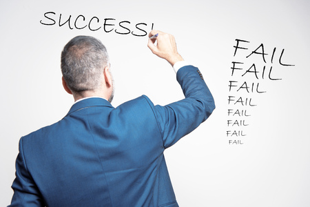 Senior business lecturer writing the words success after a long stream of failuresの写真素材