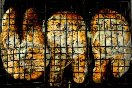 an appetizing fish on the fireの写真素材