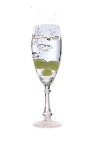 a glass of water and a grapeの写真素材
