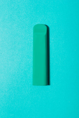 Colorful disposable electronic cigarette pod on a blue background. alternative to modern smoking,...