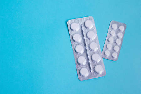 Blisters with white round pills of health and protection. Slimming, anti-aging or anti-viral....