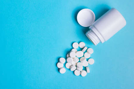 jar with white round pills of health and protection. Slimming, anti-aging or anti-viral....