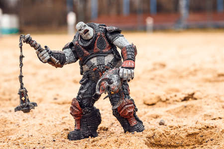 Saint Petersburg, Russia - September 26, 2021: Boomer Gears of War on the sand. The toy character of...