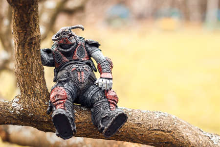 Saint Petersburg, Russia - September 26, 2021: Gears of War boomer sitting on a branch. The toy...