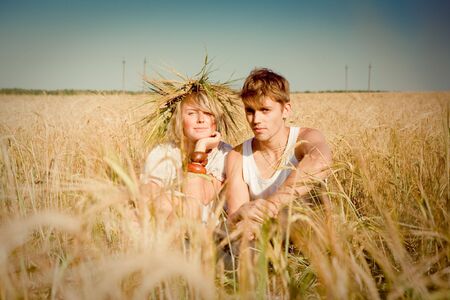 Image of happy young man and woman  on wheat fieldの写真素材