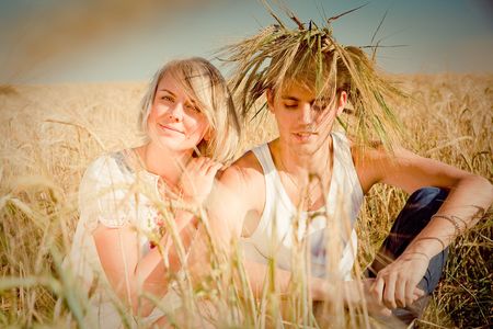 Image of happy young man and woman  on wheat fieldの写真素材