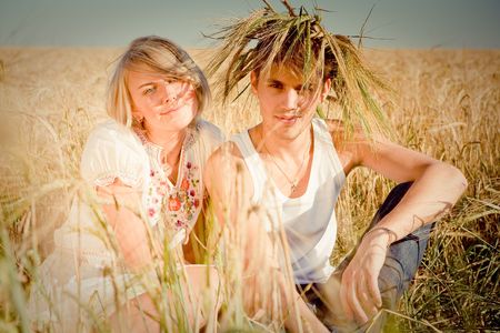 Image of happy young man and woman  on wheat fieldの写真素材