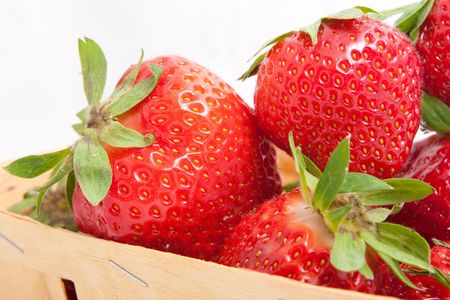 Fresh strawberries in basket isolated on whiteの写真素材
