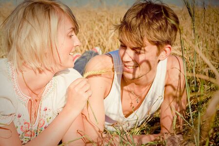 Image of happy young man and woman  on wheat fieldの写真素材