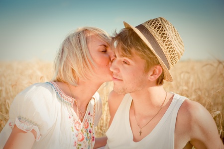 Image of young man and woman on wheat fieldの写真素材