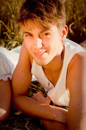 Image of young man on wheat fieldの写真素材