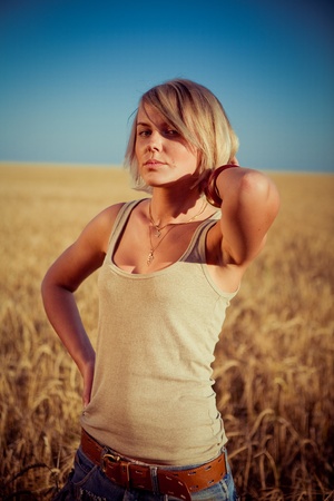 Image of young woman on wheat fieldの写真素材