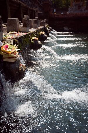 holy spring water in tirta empul, bali, indonesiaの写真素材