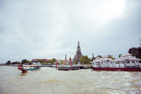 A beautiful view across the river opposite to Wat-arun temple located in Bangkok, Thailandの写真素材