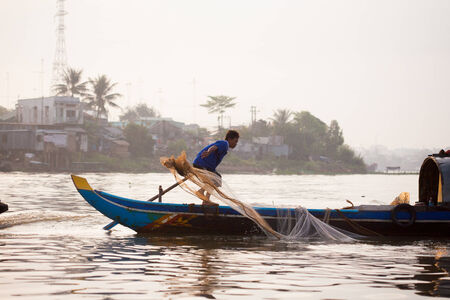 SOC TRANG, VIETNAM - JAN 28 2014: Unidentified man rowing boats in Mekong Delta. On JAN 28, 2014.のeditorial素材