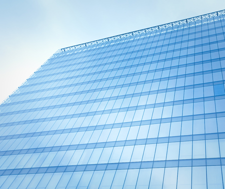 reflecting sky in glass of office building ; abstract backgroundの写真素材
