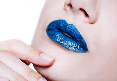 Close-up shot of woman lips with glossy blue lipstick