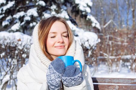 Beautiful Happy Smiling Winter Woman with Blue Mug Outdoor