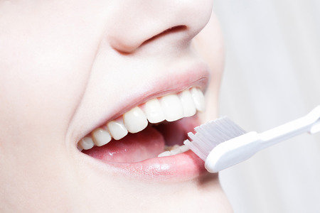 Beautiful woman with toothbrush. Dental care background.