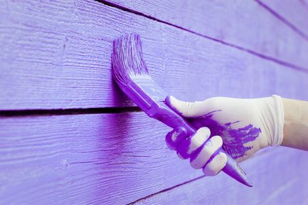 hand painting violet wooden wall