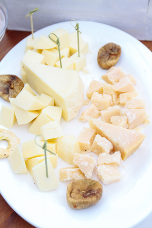Cheese plate: Emmental, Camembert cheese, blue cheese on tableの写真素材
