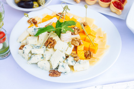 Cheese plate: Emmental, Camembert cheese, blue cheese on tableの写真素材