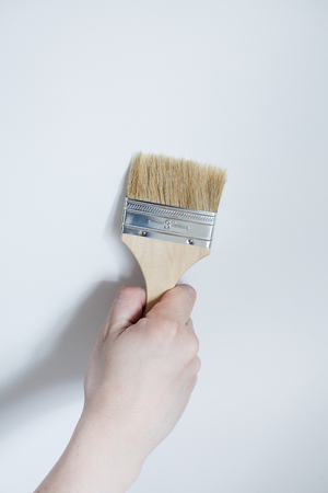 Painter painting the white wall in house. Close up brushの写真素材