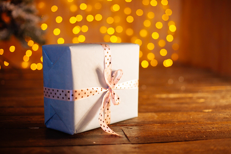 Christmas presents with decorative xmas  ribbons on round lights bokeh backgroundの写真素材