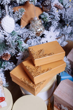 Christmas presents with decorative xmas  ribbons on fur tree backgroundの写真素材