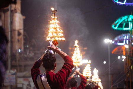VARANASI, INDIA- 23 JANUARY 2017 : A Hindu priest performs the Ganga Aarti ritual in Varanasi. Fire...