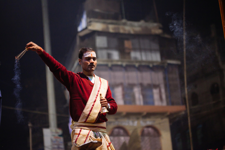 VARANASI, INDIA- 23 JANUARY 2017 : A Hindu priest performs the Ganga Aarti ritual in Varanasi. Fire puja is a Hindu ritual that takes place at Dashashwamedh Ghat on the banks of the river Gangesのeditorial素材