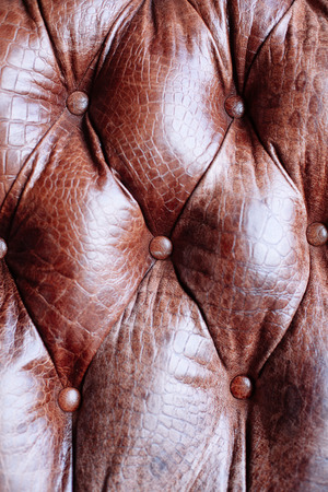 Closeup texture of vintage brown leather sofa in roomの写真素材