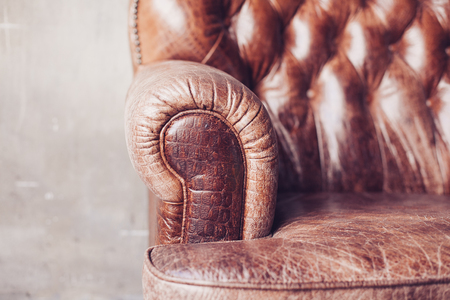 Closeup texture of vintage brown leather sofa in roomの写真素材