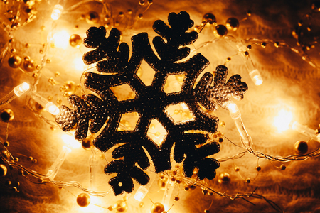 Christmas and New Year decorations snowflake on yellow lights backgroundの写真素材