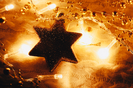 Christmas and New Year decorations star on yellow lights backgroundの写真素材