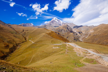 Caucasian mountains. A view of snow-covered summit of Mount Kazbegi, Georgiaの写真素材