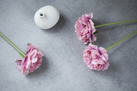 Mock up composition: concrete table, flowers, and vaseの写真素材