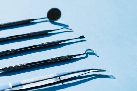 dentist tools on blue background: Dental Hygiene and Health conceptual image