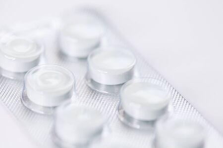 Close up of white tablets, pills in blister pack, medications drugs, macro, selective focusの写真素材