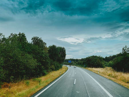 Asphalt road and beautiful nature landscape at sunsetの写真素材